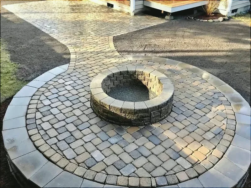 Circular paver patio with a stone fire pit